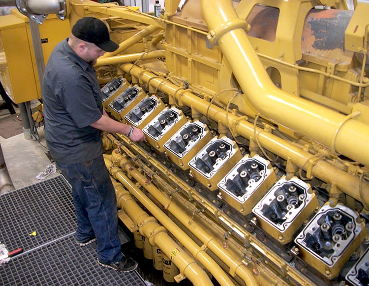 6 - Biogas Power Generation Facility - Operattions & Maintenance Services - guy working on CAT engine